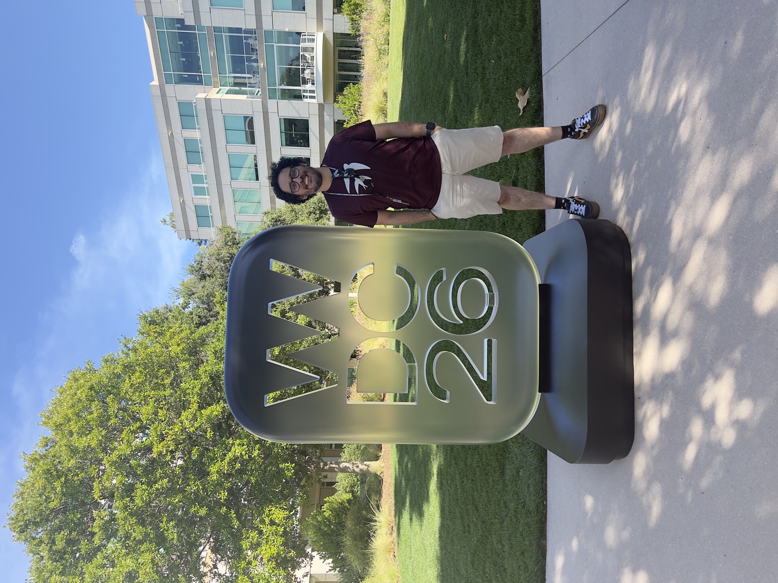 Ezequiel beside the WWDC 26 sign at Apple Park on a sunny day